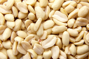 Raw blanched peanuts as food background