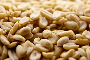 Raw blanched peanuts as food background
