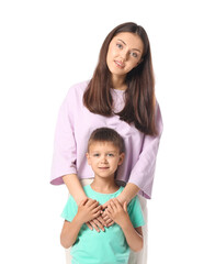 Little boy with his older sister on white background