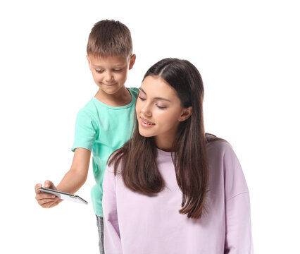 Little Boy And His Older Sister With Mobile Phone Taking Selfie On White Background