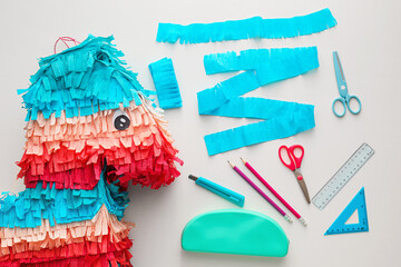 Materials for making Mexican pinata in shape of horse on white background