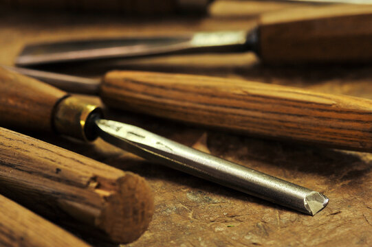 A detailed horizontal close up of a roughing gouge and other woodworking tools on a wooden table, Johannesburg, South Africa