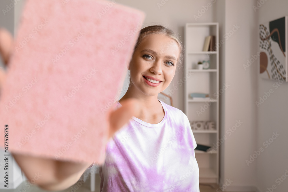 Poster Young woman with sponge at home