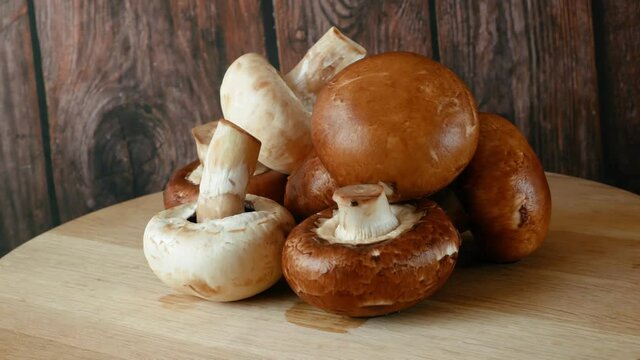 Fresh Brown and White Champignon Mushhrooms in backet on wooden background, Royal champignon mushrooms