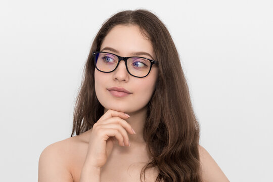 Teenager in glasses, beauty photo on a white background. Girl with big blue eyes.