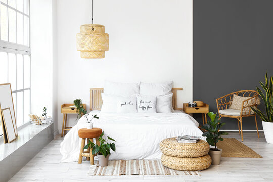 Interior of light modern bedroom with wooden nightstands