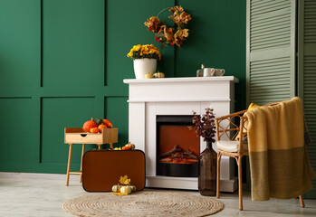 Interior of stylish room with modern fireplace, armchair and table