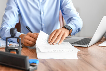 Young businessman working with documents in office