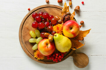 Board with different healthy food on light wooden background. Harvest festival