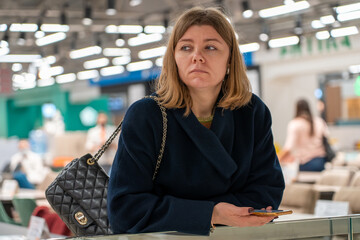 Close up portrait of serene portrait of tired sad young adult caucasian fashion woman wearing coat...