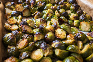 oven baked sliced brussels sprouts on baking tray closeup