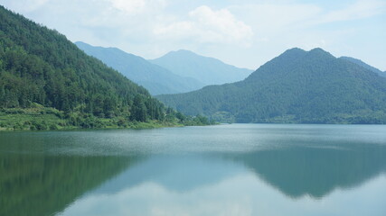 The beautiful lake landscapes surrounded by the green mountains in the countryside of the China