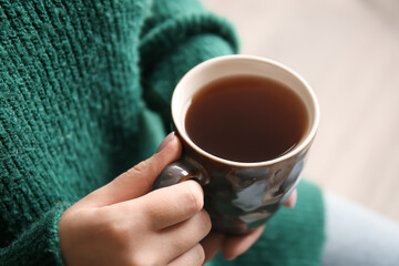Woman drinking tasty tea, closeup