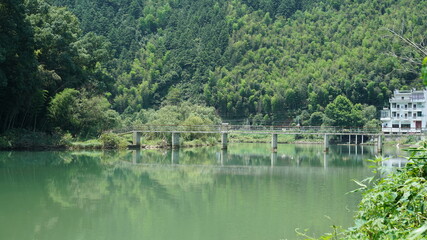 Fototapeta na wymiar The beautiful lake landscapes surrounded by the green mountains in the countryside of the China