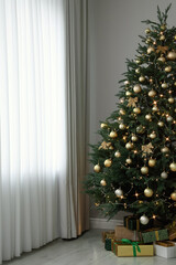 Beautifully decorated Christmas tree and gifts indoors