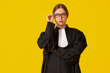 Young female judge on color background