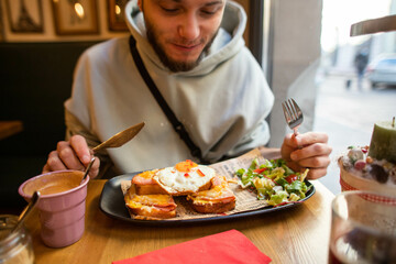 eating breakfast with eggs in a cafe
