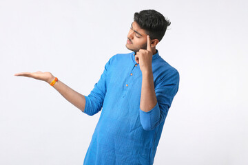 Indian man in tradition wear and giving expression on white background.