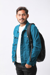 Fototapeta premium Young indian college student giving expression on white background.
