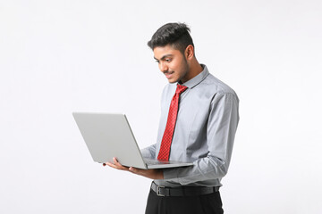 Young indian man using laptop on white background.