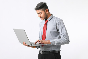 Young indian man using laptop on white background.