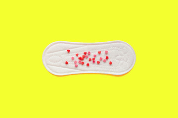 Feminine hygiene photo. Menstrual woman pads for hygiene protection in critical days, cycle blood period concept. Menstruation sanitary and gynecological soft pad with hearts on it. Flat lay, top view