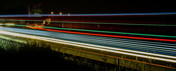 Night road lights. Lights of moving cars at night. long exposure red, blue, green