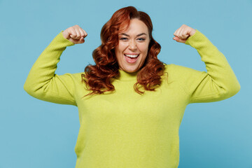 Young strong fun chubby overweight plus size big fat fit woman in green sweater showing biceps...