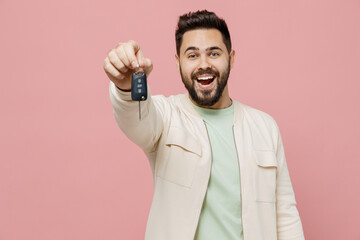 Young smiling happy excited caucasian man 20s wearing trendy jacket shirt hold give car key fob...