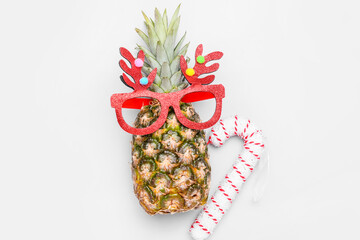 Fresh pineapple with Christmas decor on white background