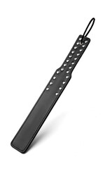 Detailed shot of a black leather paddle with steel rivets and a loop for fixing on a wrist. The accessory for erotic games is isolated on the white background.