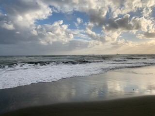 Fototapeta na wymiar Amazing sky reflection at the sea coast, sand beach, evening time, natural background