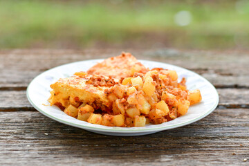  Potato and minced meat  Casserole  with   parmesan cheese and garlic on wooden rustic bakcground.  Bulgarian moussaka
