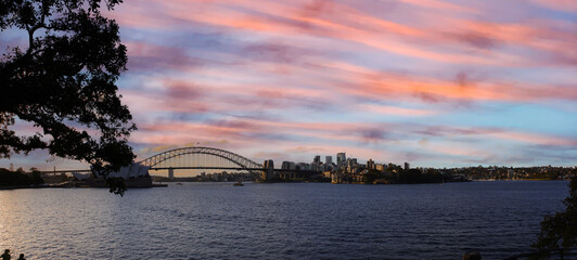 Fototapeta na wymiar View of Sydney Harbour NSW Australia. Ferry boats partly cloudy colourful skies blue waters