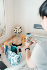 Girl Taking A Photo of a Hat in a mediterranean hotel room