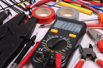 Colored electrical wiring wires, mounting tools, multimeter, are arranged in a schematic diagram.
