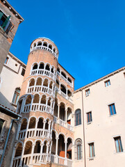 Palace Contarini del Bovolo with unusial tower with spiral arches. Beautiful spiral staircase with arched windows in Venice, Italy.