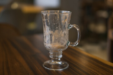 Empty latte glass cup on the table in coffee shop. High quality photo