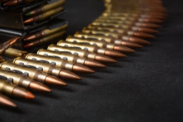 Photo of 5.56mm NATO Ammunition, machine gun bullets belt, rifle ammunition in magazines - obrazy, fototapety, plakaty