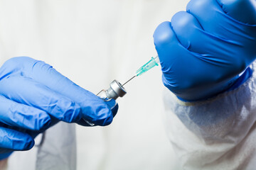 Closeup of syringe with needle in vaccine ampoule vial