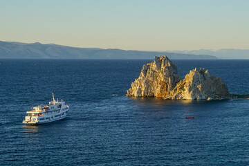 Shaman rock and cruise ship at sunset on Baikal