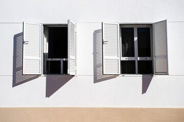 Two open windows on white wall .Abstract geometric background in black and white