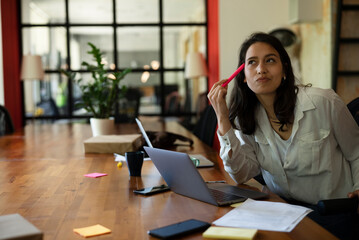 Businesswoman in office. Beautiful young woman working on computer at her workplace