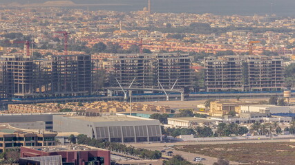 Construction site around Dubai water canal with pedestrian bridge over it aerial timelapse.