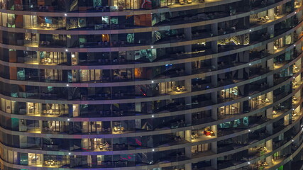 Outside view of windows in apartments of a high class building at night timelapse