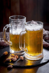 Light beer in a glass on an old background.