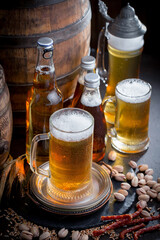 Light beer in a glass on an old background.