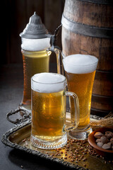 Light beer in a glass, on an old background.