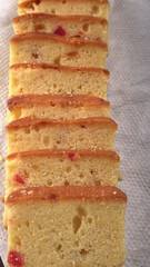 Slices of home made wholemeal bread on a white background with wheat and flour.