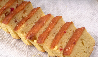 Slices of home made wholemeal bread on a white background with wheat and flour.